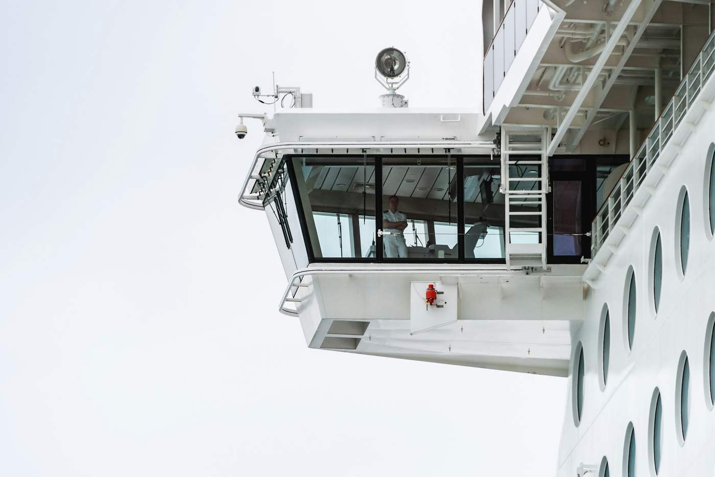 The bridge wing of a vessel, its glazed control station projecting out over the ship's side.